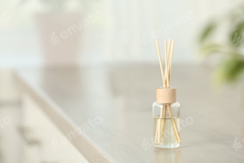 Preview: Reed air freshener on table indoors, space for text