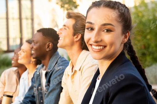 Preview: Beautiful brunette young woman spending time with her multiethnic friends