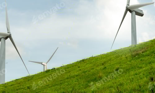 Preview: Wind Turbines on Green Grassy Hillside Against Sky