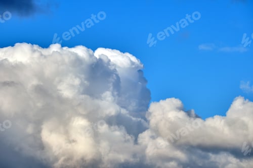 Preview: Bright landscape of white puffy cumulus clouds on blue clear sky