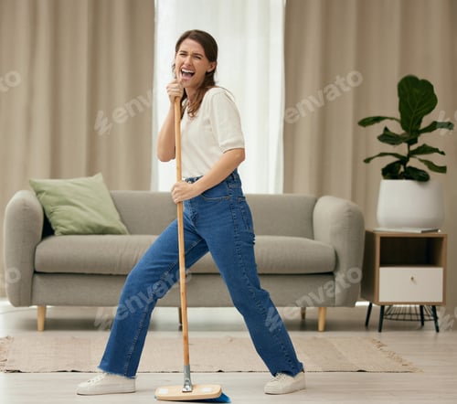 Preview: Fun was had. Shot of a young woman singing while sweeping the floors at home.