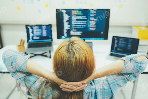 Preview: Young programmer or IT specialist satisfied with her work done.