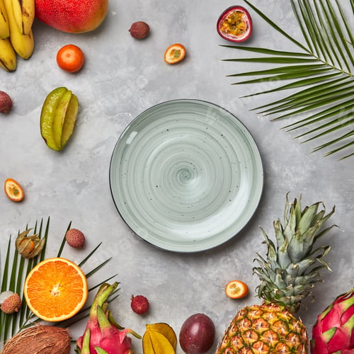 Preview: Juicy ripe tropical fruits, pineapple, papaya, mango, pineapple, green palm leaves and empty round