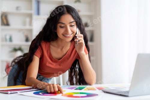 Preview: Woman Freelance Designer Working With Laptop And Cellphone At Home