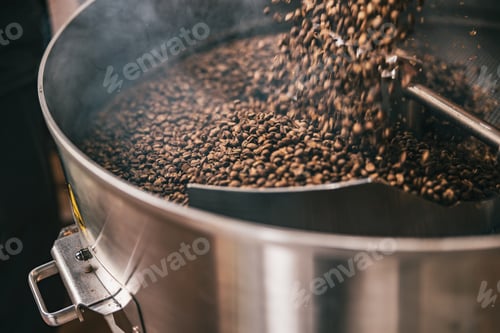 Preview: Close up of coffee beans in coffee roasting machine in a small manufacturing