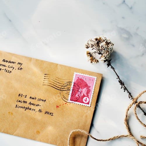 Preview: Aerial view closeup of brown envelope on marbel table