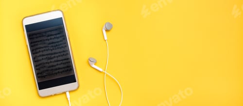 Preview: Listening to music using a smartphone and wired headphones. Leisure with gadgets. Top view