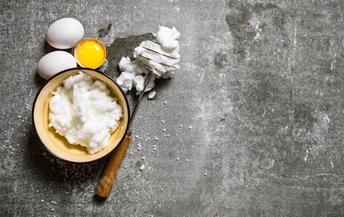 Preview: Whipped eggs in a bowl with a whisk.