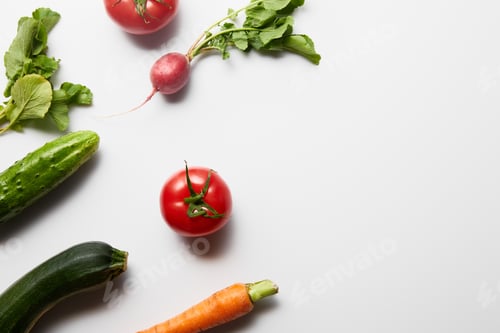 Preview: top view of raw fresh vegetables with green leaves on white background with copy space
