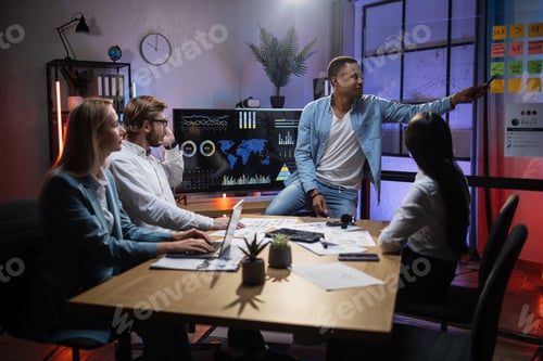 Preview: Multiracial financiers discussing company incomes at office