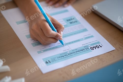 Preview: Close up of woman filling individual tax declaration