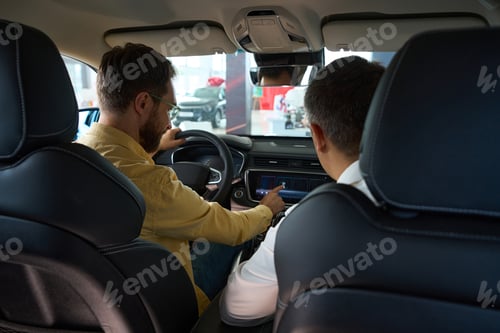 Preview: Men sit in the interior of a modern car