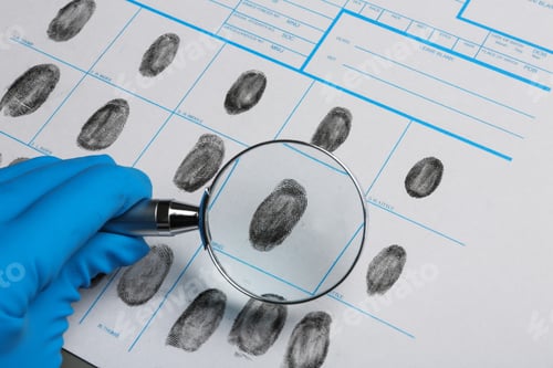 Preview: Criminalist studying fingerprints with magnifying glass, closeup