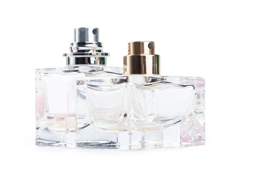 Preview: Two perfume bottles placed closely on a bright background during daylight hours