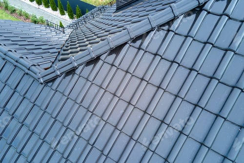 Preview: Closeup of house roof top covered with shiny ceramic shingles