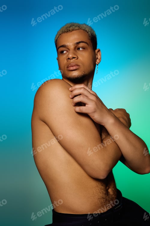 Preview: Young African American man showcases beauty and fashion in a colorful studio setting