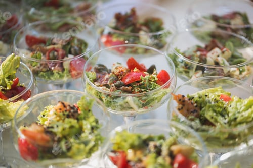Preview: Reception at the wedding. Snacks and wine glasses on a glass table.