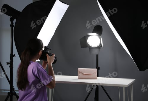 Preview: Professional photographer shooting stylish bag in studio
