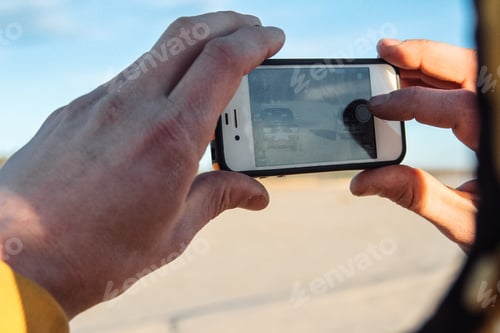 Preview: recording video on the phone in male hands