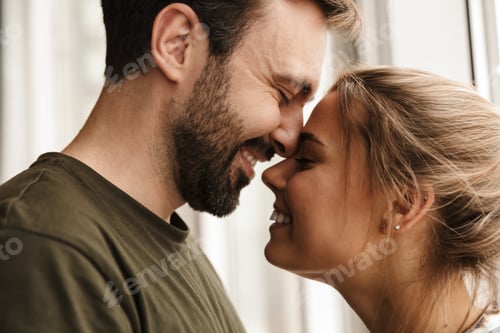 Preview: Photo of romantic cute couple smiling and hugging while standing