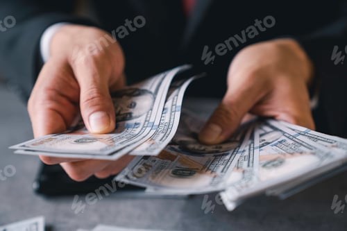 Preview: businessman counts money in hands. savings, finances, economy and home concept - close up of man cou