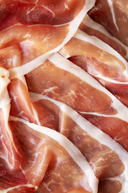 Preview: Sliced Prosciutto Ham on a Plate, top view. Close-up.