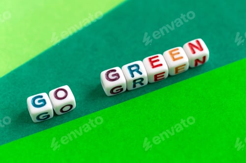Preview: Phrase’Go Green’ made out of colorful beads on bright green background, ecological concept
