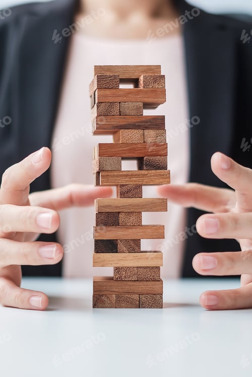 Preview: Businesswoman hand cover wooden block on the tower. Business planning, Risk Management, Solution