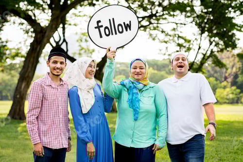 Preview: Muslim family holding up a follow sign