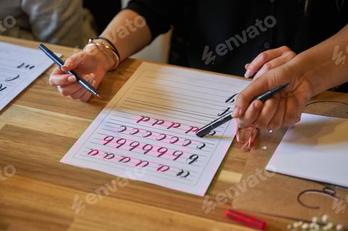 Preview: Crop teacher showing student how to write letters
