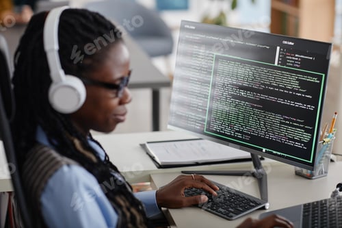 Preview: Working on Computer Programming with Headphones in Office
