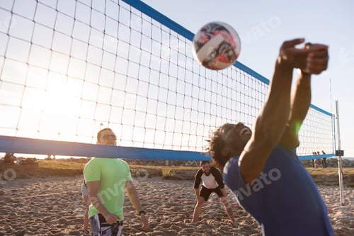 Preview: Friends playing volleyball on beach