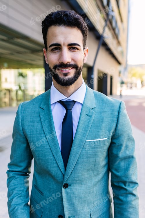 Preview: Young successful businessman smile at camera standing outside