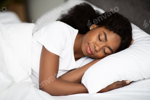 Preview: Closeup shot of young african american woman sleeping in bed