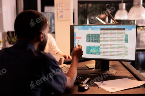 Preview: Employee analyzing global fund market investment statistics on computer