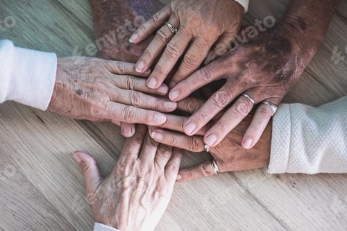 Preview: Top view of six caucasian old hands put in circle show unity and support, together on wooden surface