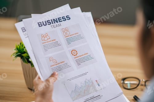 Preview: Young woman working with paperwork at home