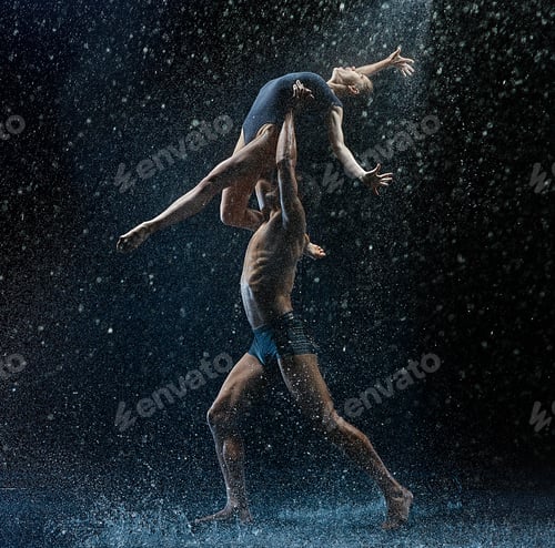 Preview: Young couple of ballet dancers dancing unde rwater drops