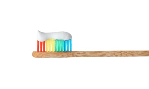 Preview: Bamboo toothbrush with paste on white background. Dental care