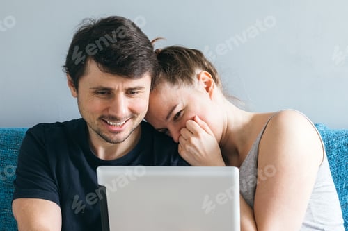 Preview: Loving Couple Laughing Together Using a Tablet
