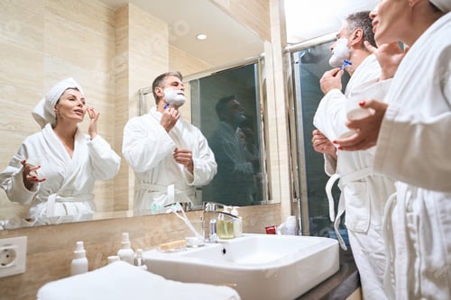 Preview: Couple taking care of their faces in the bathroom