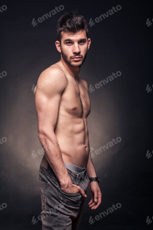 Preview: One Young Adult Handsome Man, Shirtless, Hand In Pocket, Side View, Black Background Studio
