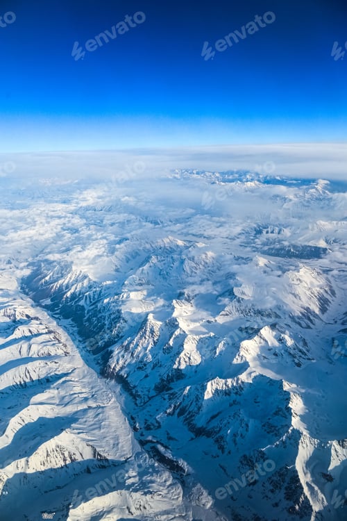 Preview: Aerial view of snow-covered mountains.
