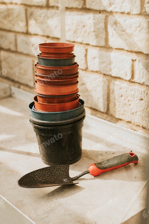 Preview: Empty flower pots near a trowel