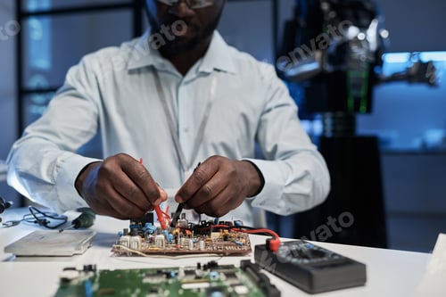 Preview: Engineer working with computer board in office