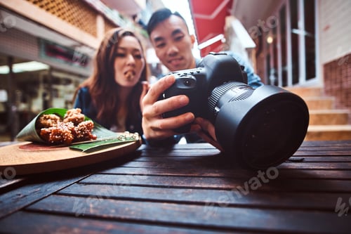 Preview: Asian couple enjoy chinese food and watching pictures