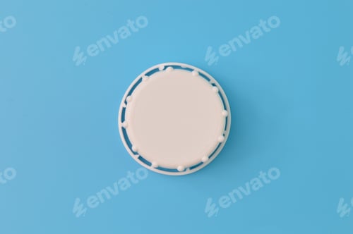 Preview: Close up view of white bottle cap isolated on a blue background