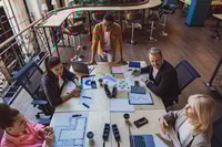 Preview: Coworkers in a Modern Meeting Room Discussing Plans