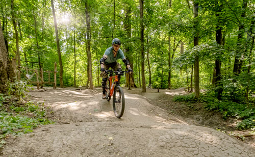 Preview: Man riding bicycle on forest road