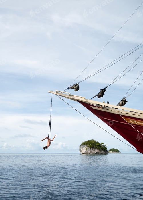 Preview: Circus girl hanging from the front of a boat